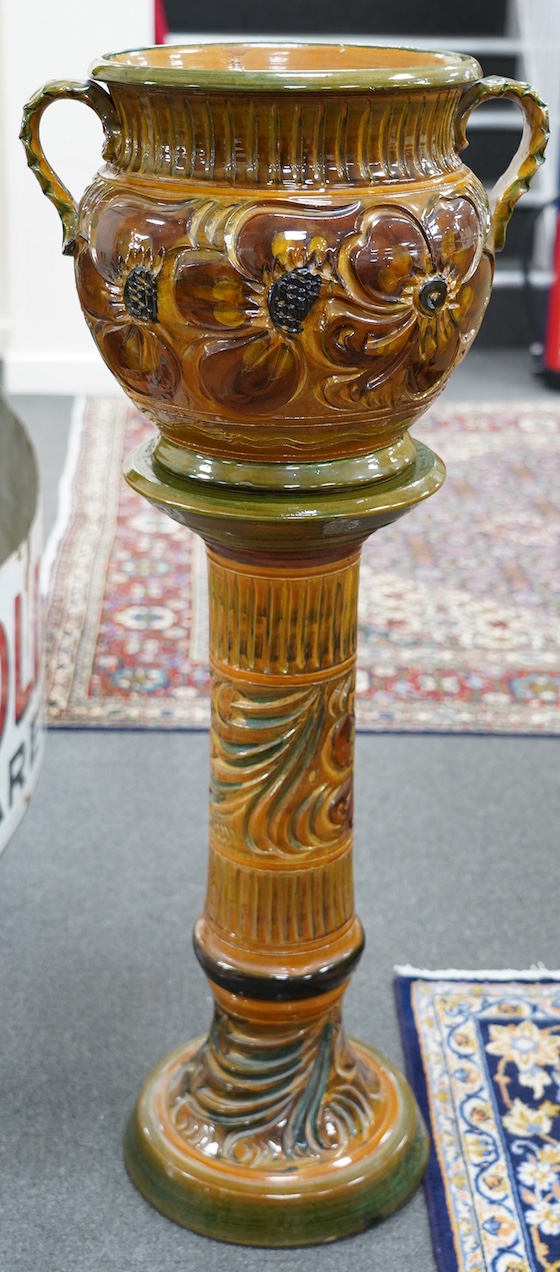 A terracotta jardiniere on stand with incised stylised floral decoration, 102cm high. Condition - good